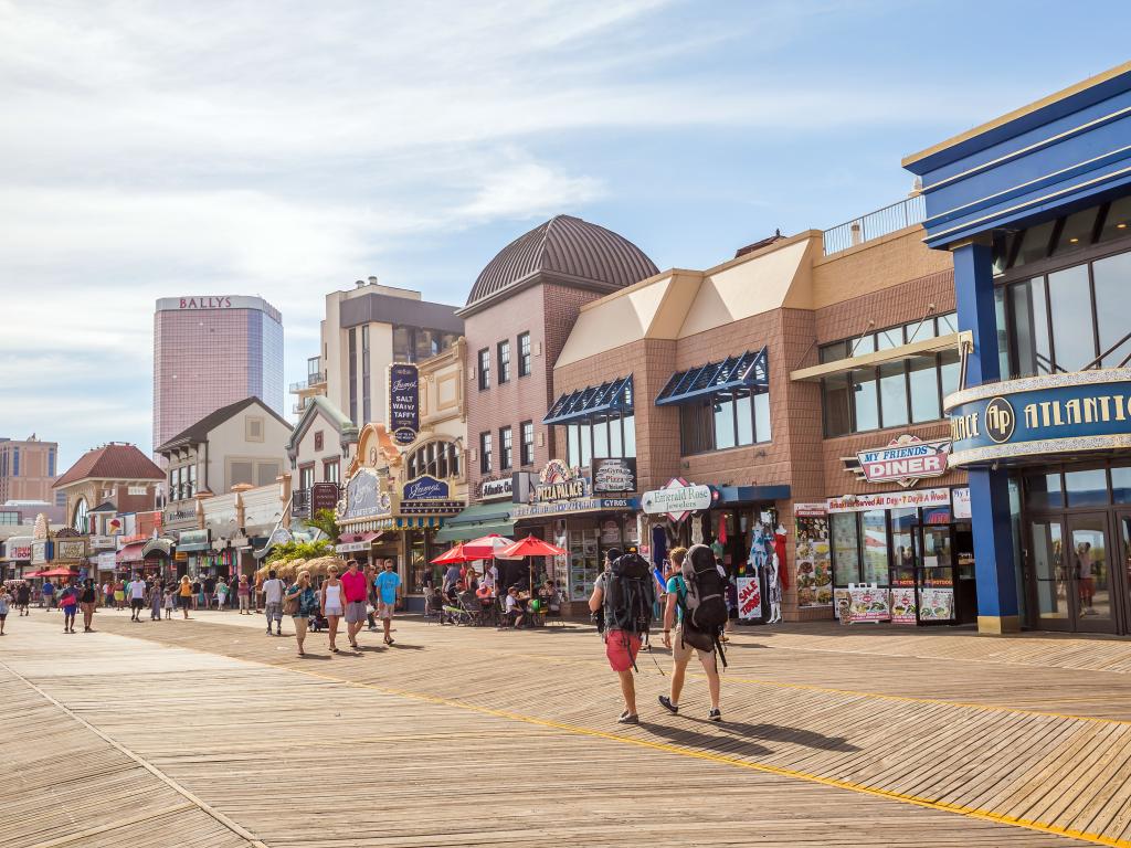 The pedestrian Boardwalk in Atlantic City, New Jersey with casinos and shops.