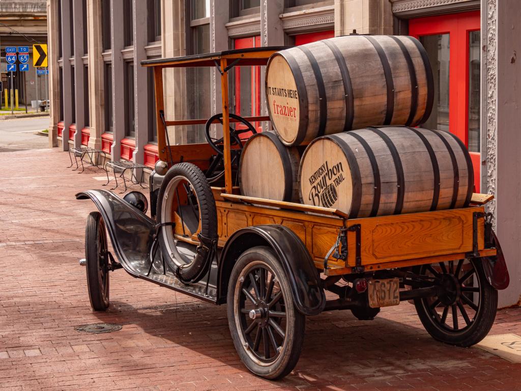 Vintage cart stacked with bourbon barrels on a historic street in Louisville, KY