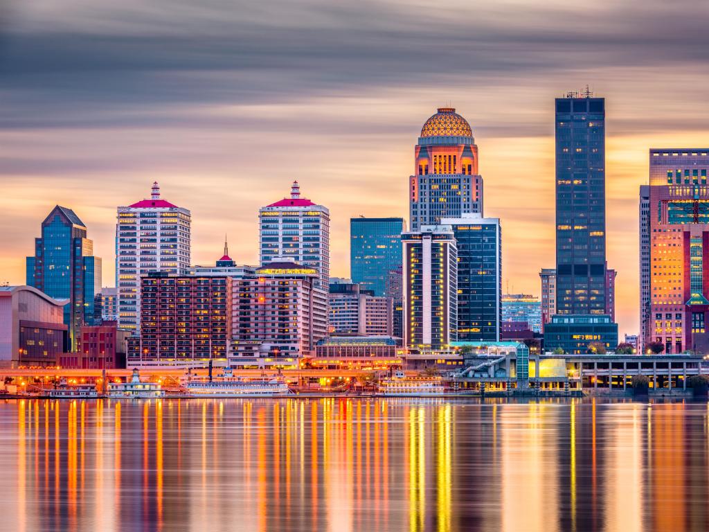 Louisville, Kentucky, USA downtown skyline on the Ohio River at dusk.