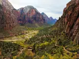Zion National Park, Utah, USA with a view of a winding trail on a clear day with cliffs either side.