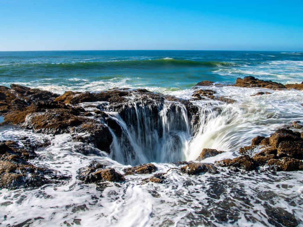 Mysterious well in the ocean with water cascading into a hole on the Oregon coastline.