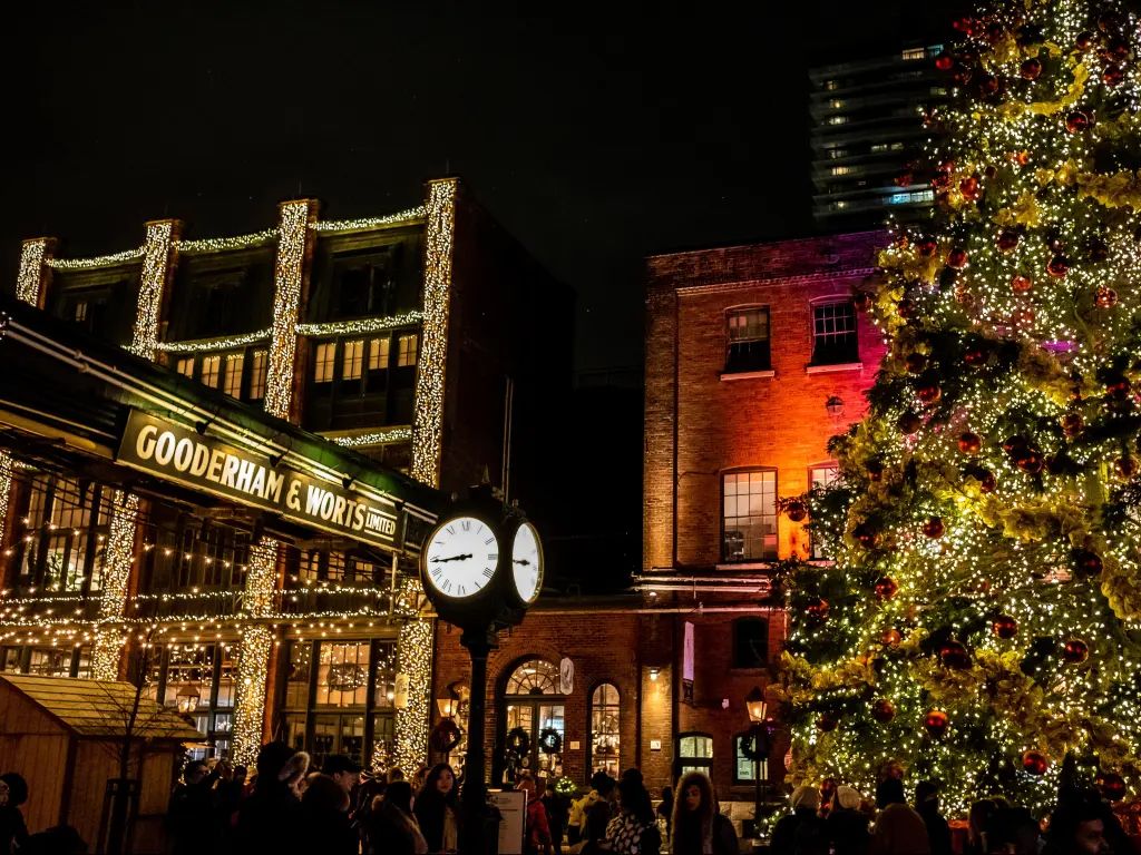 Visitors enjoy the traditional atmosphere at the Distillery District's Christmas Market in Toronto at night