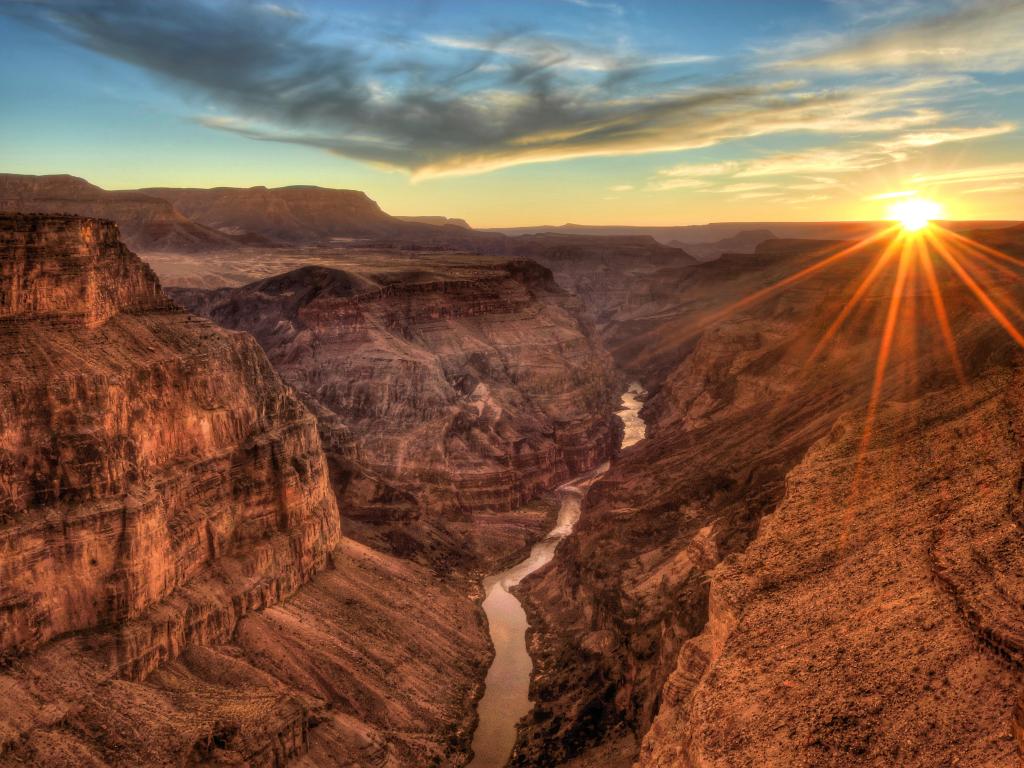 Grand Canyon National Park, Arizona at sunset looking down at the valleys and the river below with the canyons reaching to the distance. 