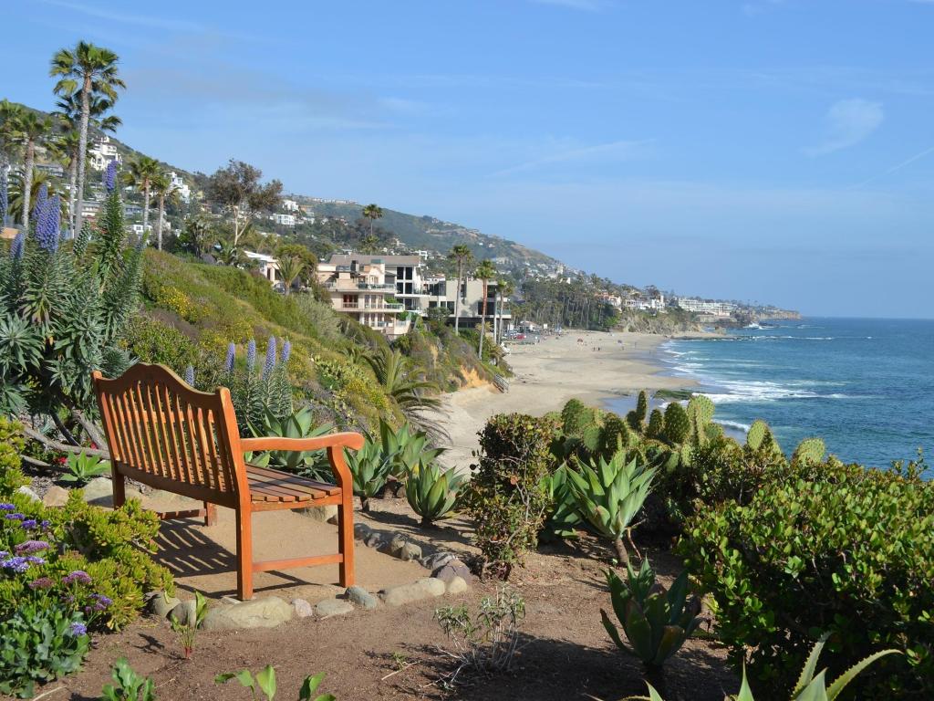 Wooden beach along the clifftop of Heisler Park in Laguna Beach, overlooking the sandy beach and ocean