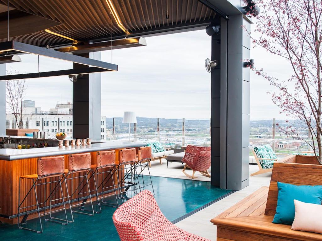View of outdoor terrace and bar, with panoramic city views at Noelle, Nashville