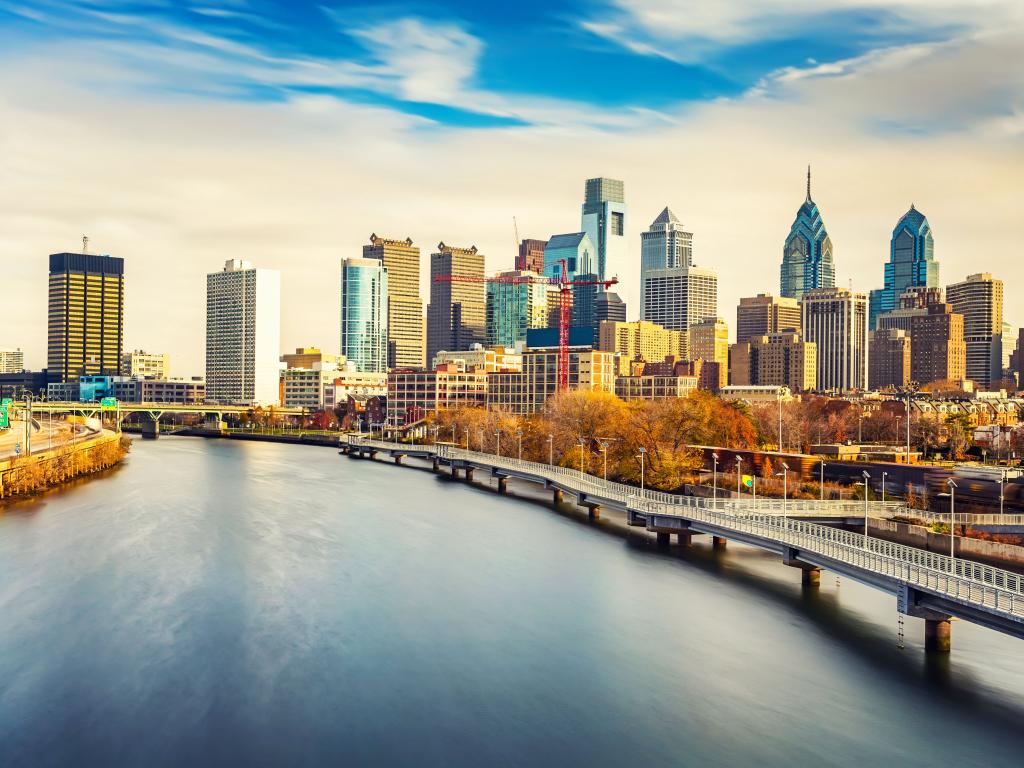 Panoramic view of Philadelphia skyline and Schuylkill river with patches of blue sky