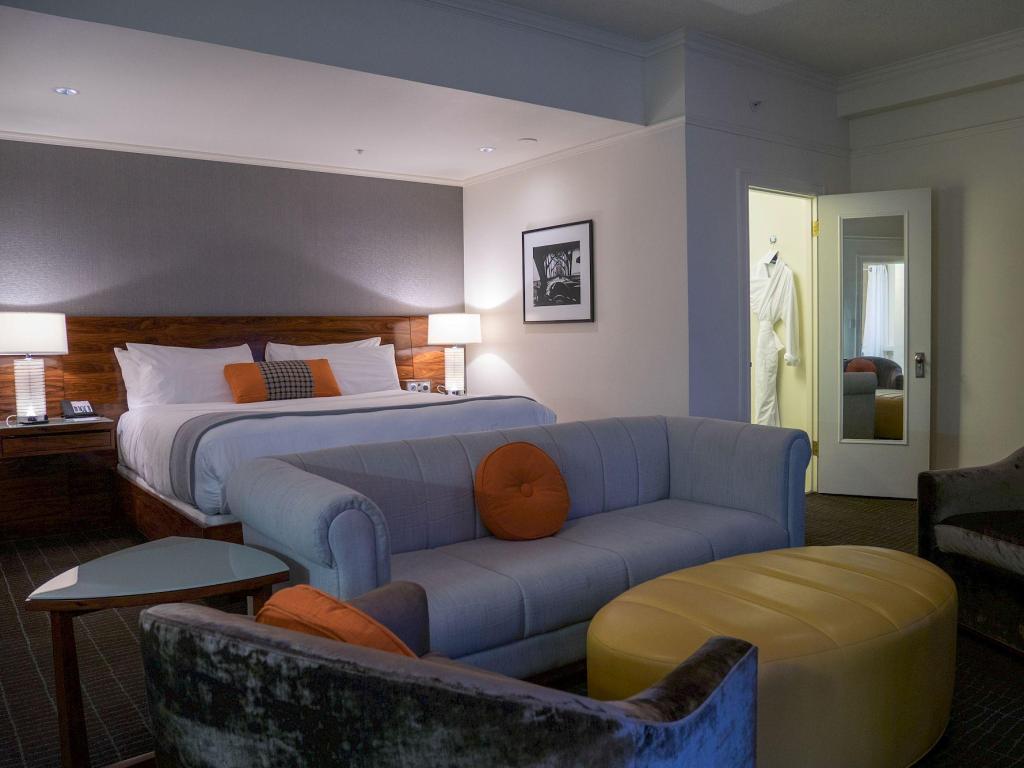Stylish pale blue and orange bedroom design at Hotel Lucia, Portland