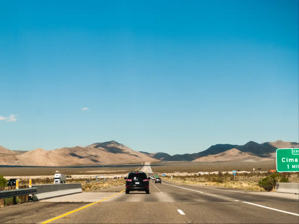 Interstate 15 freeway in Mojave on a sunny morning with a scenic view of the mountains.