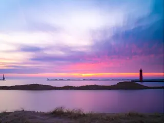 Beautiful sunset over the lighthouse in Muskegon Michigan at the beach