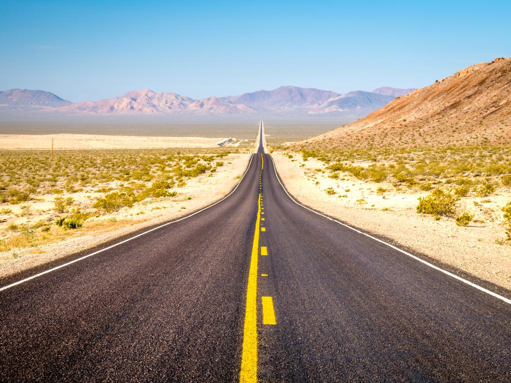 Road stretching into the distance through the Death Valley National Park in California.