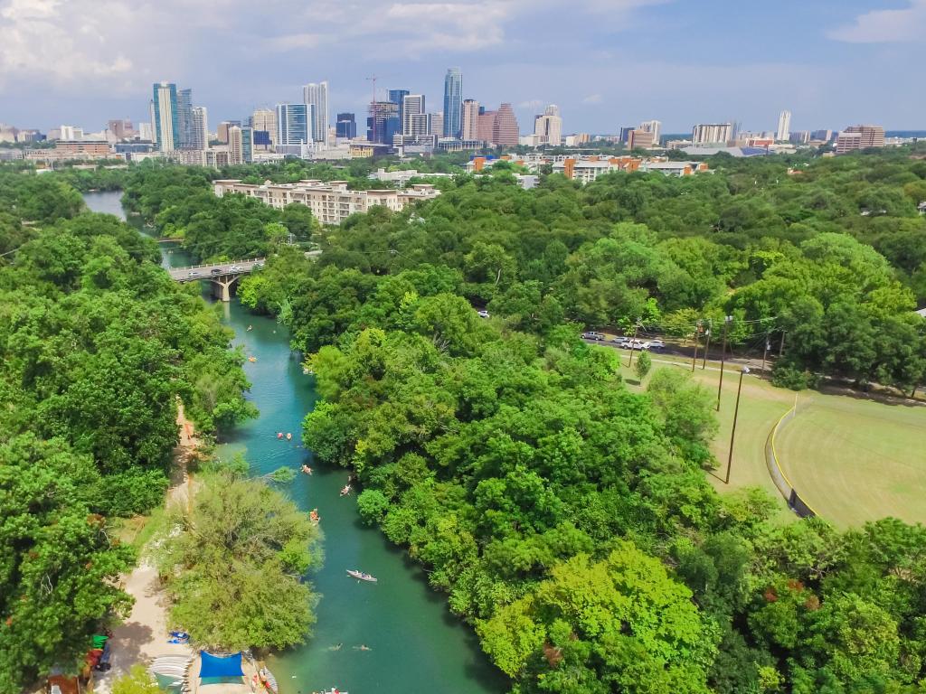 An aerial shot of Zilker Metropolitan Park in south Austin. Photo is taken in summer with blue sky. 