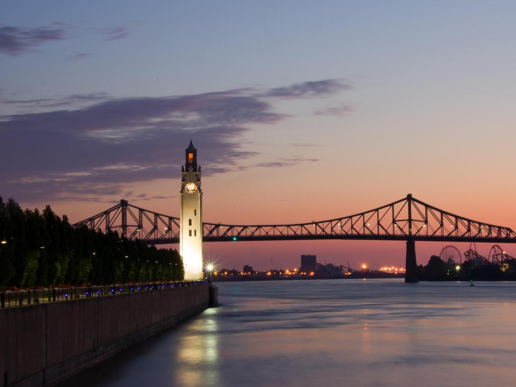 St. Lawrence River, Canada with Big Ben in Old Montreal, and Jacques-Cartier Bridge in background, taken at a beautiful sunrise.