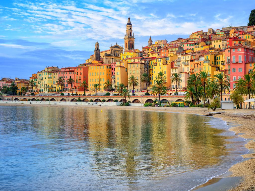 Sand beach beneath the colorful old town Menton on french Riviera, France