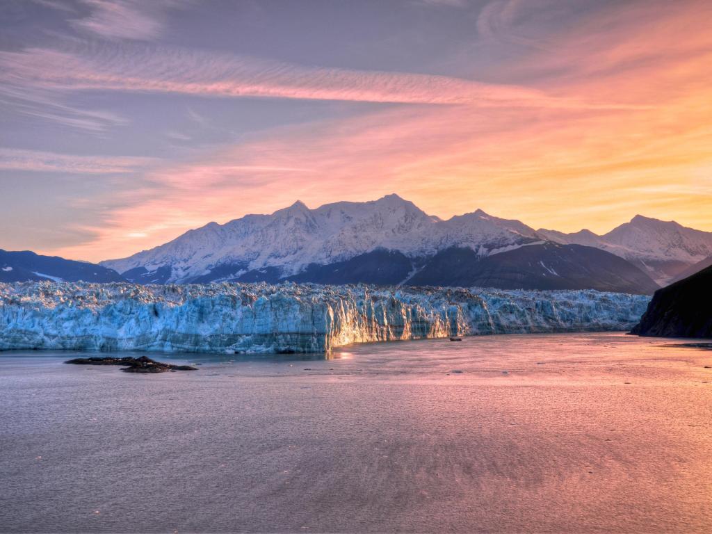Orange and purple-hued sunrise at Hubbard Glacier Alaska