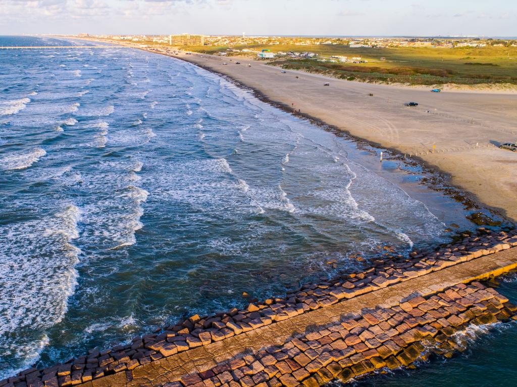 Scenic fishing pier and beach in Port Aransas on Mustang Island, Texas.