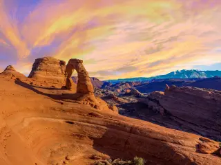 Beautiful orange and pink sunset with the Delicate Arch in focus