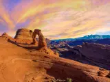 Beautiful orange and pink sunset with the Delicate Arch in focus