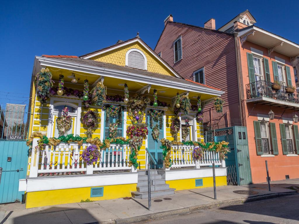 Old Colonial Houses on the Streets of French Quarter decorated for Mardi Gras in New Orleans, Louisiana