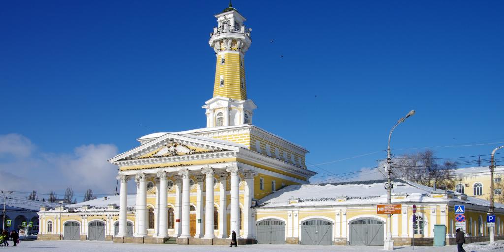 The yellow fire tower in Kostroma, Russia, in the snow on a sunny day