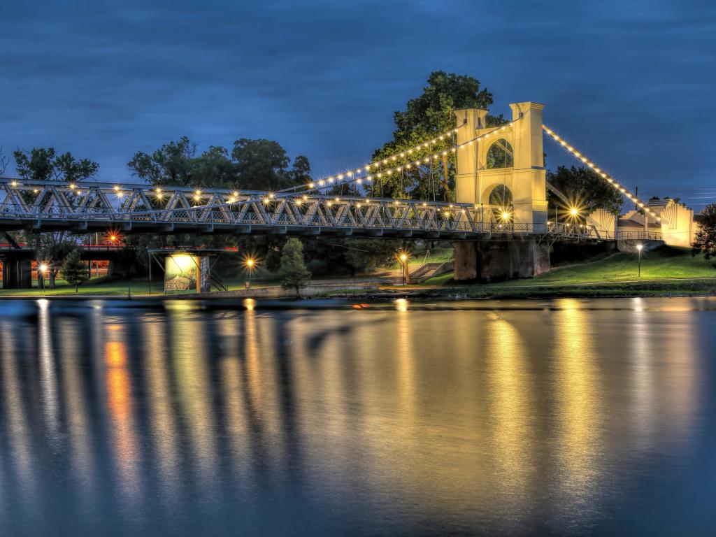 Historic Waco Suspension Bridge across the Brazos River in the evening in Waco, Texas