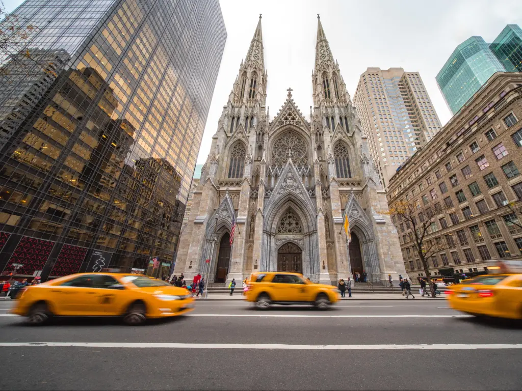 Striking gothic St. Patrick's Cathedral amongst the skyscrapers, with yellow cabs in the forefront