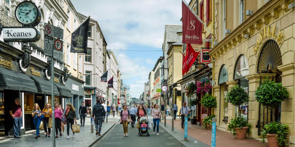 People walking down Oliver Plunkett Street in Cork, Ireland
