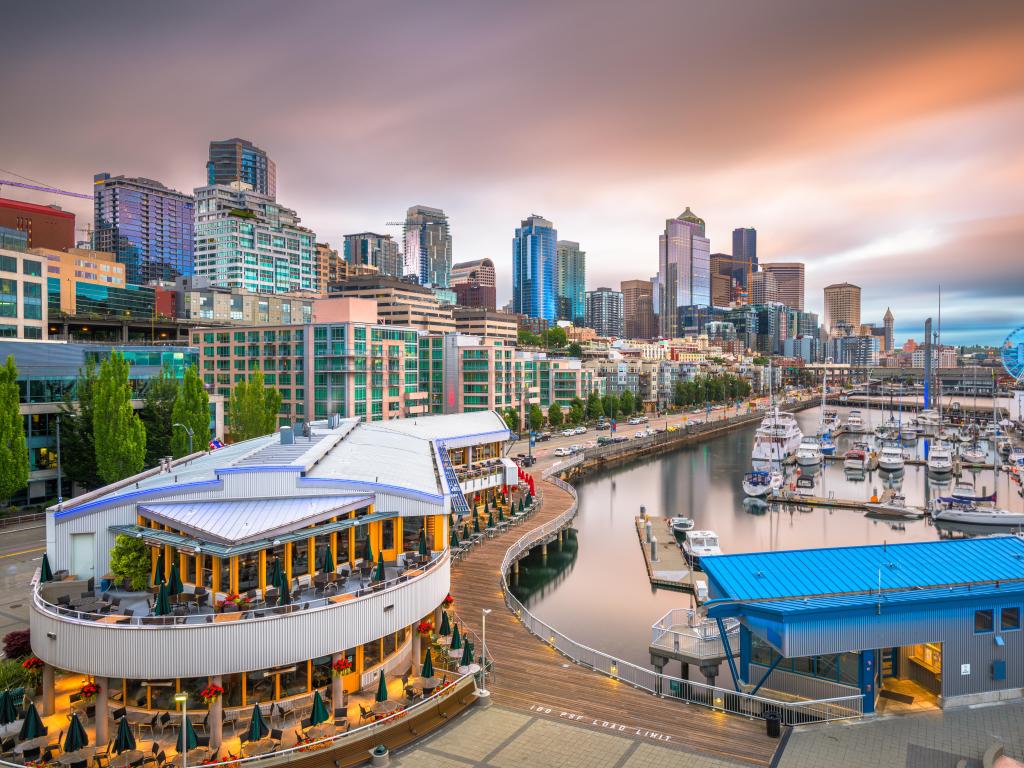 Seattle, Washington, USA with the pier and skyline at dusk and sailing boats in the foreground. 