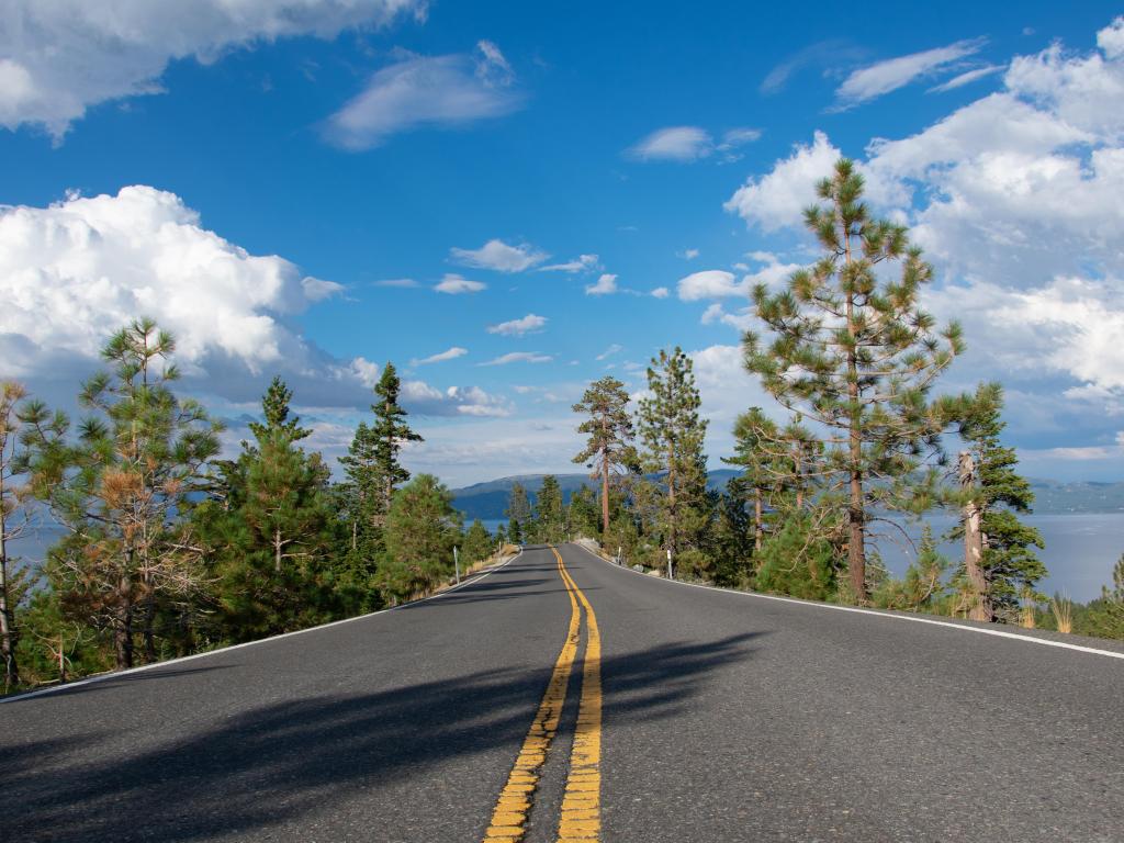 Emerald bay road, South Lake Tahoe in summertime. Lake view in front and from both sides of the road.