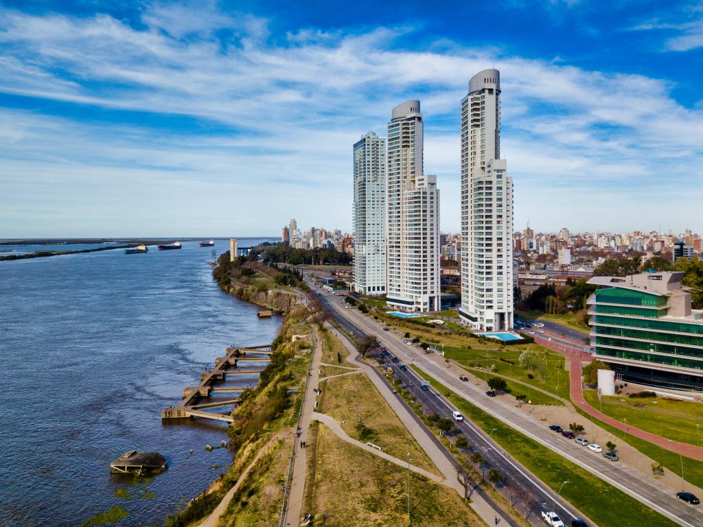 Top view image of the bustling city of Rosario, Argentina with the Parana River on the left side and the skyscrapers on the right side.