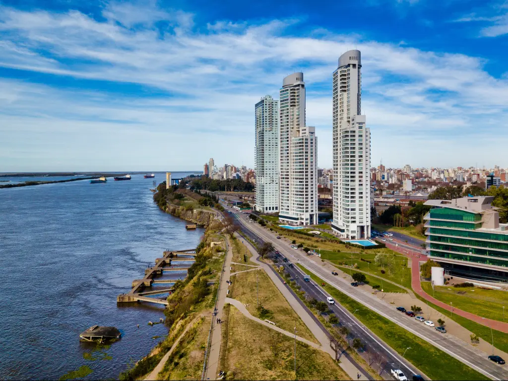 Top view image of the bustling city of Rosario, Argentina with the Parana River on the left side and the skyscrapers on the right side.