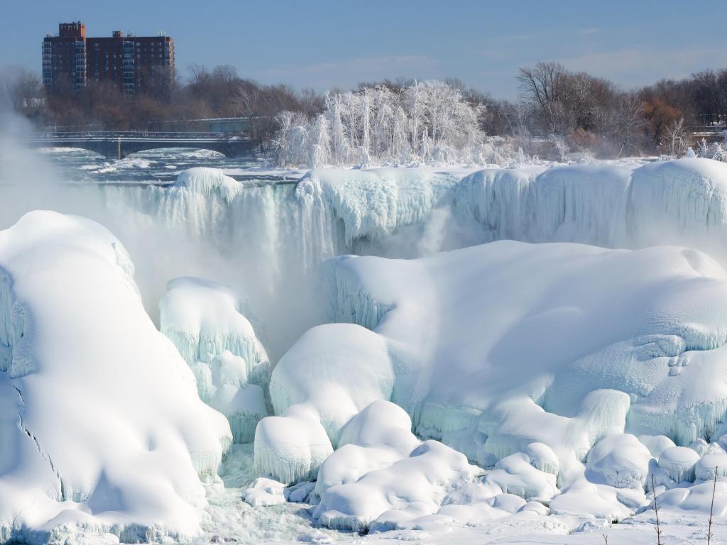 Niagara falls covered with snow and ice.