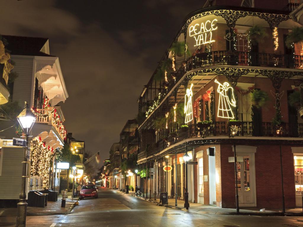 Christmas decorations light up buildings in New Orleans' French Quarter at night