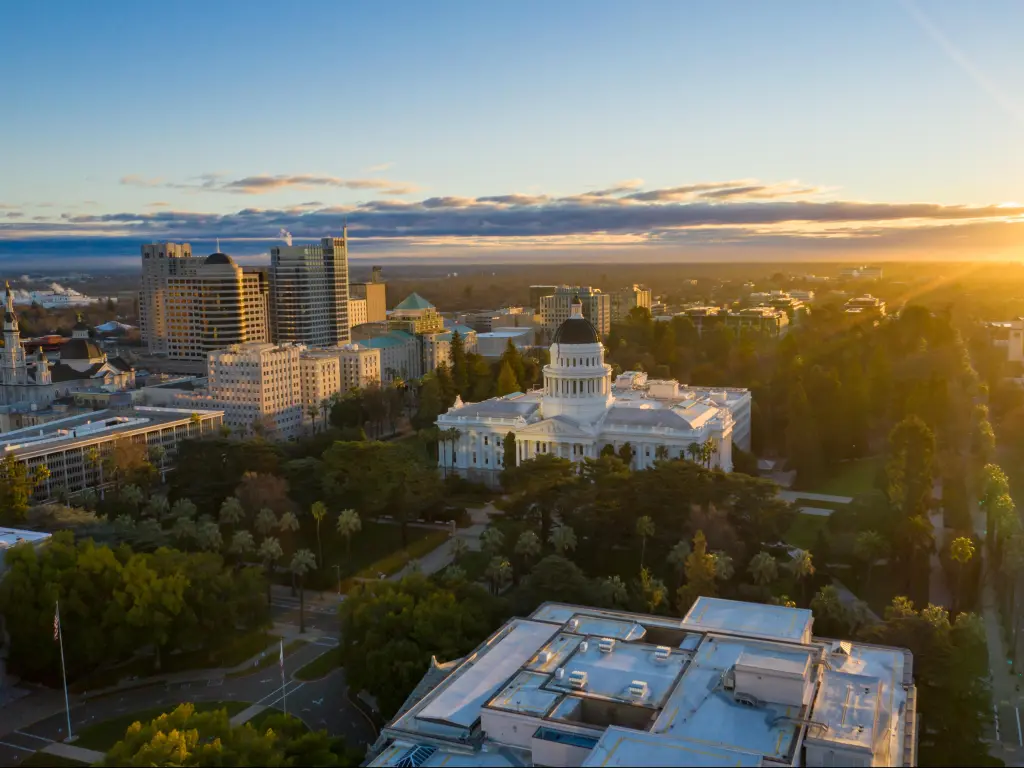 Sacramento, California, USA with a drone view of California State Capitol Building and downtown Sacramento during Sunrise.