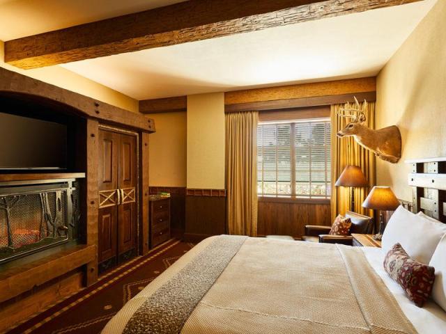 Rustic lodge style bedrooms, with deers head and fireplace at Big Cypress Lodge, Memphis