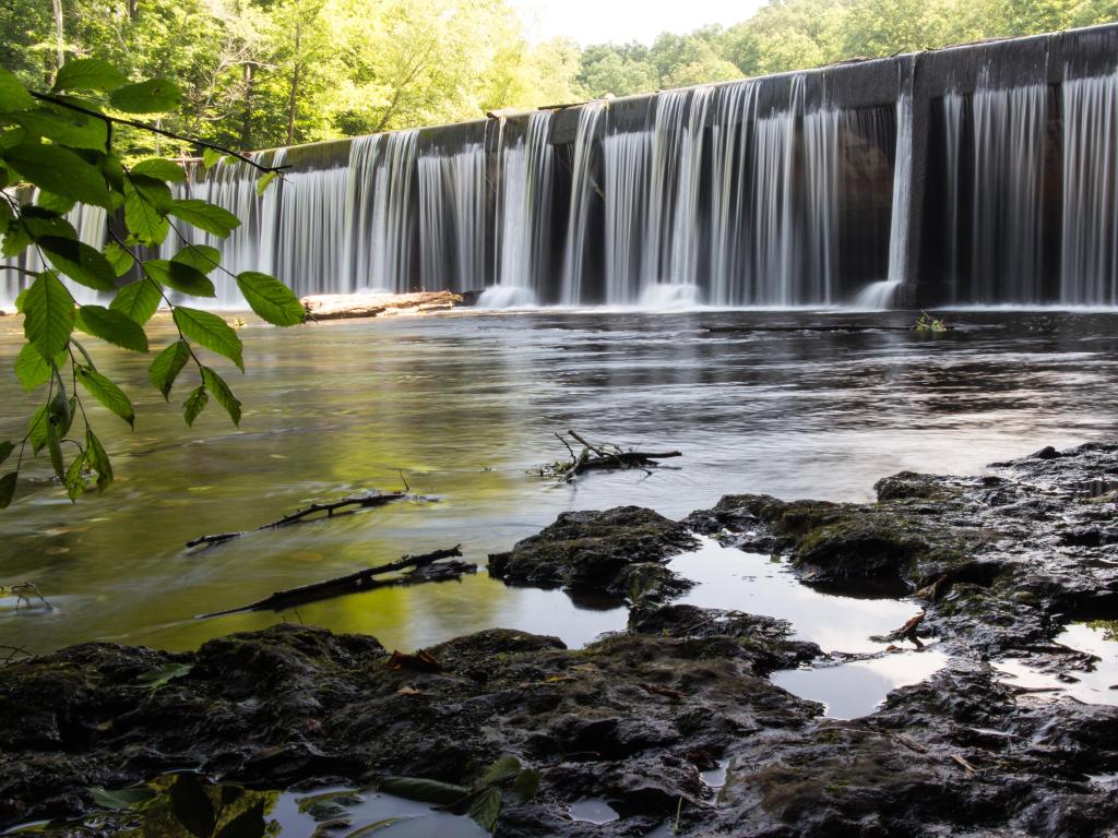 Waterfall over a dam on a sunny day