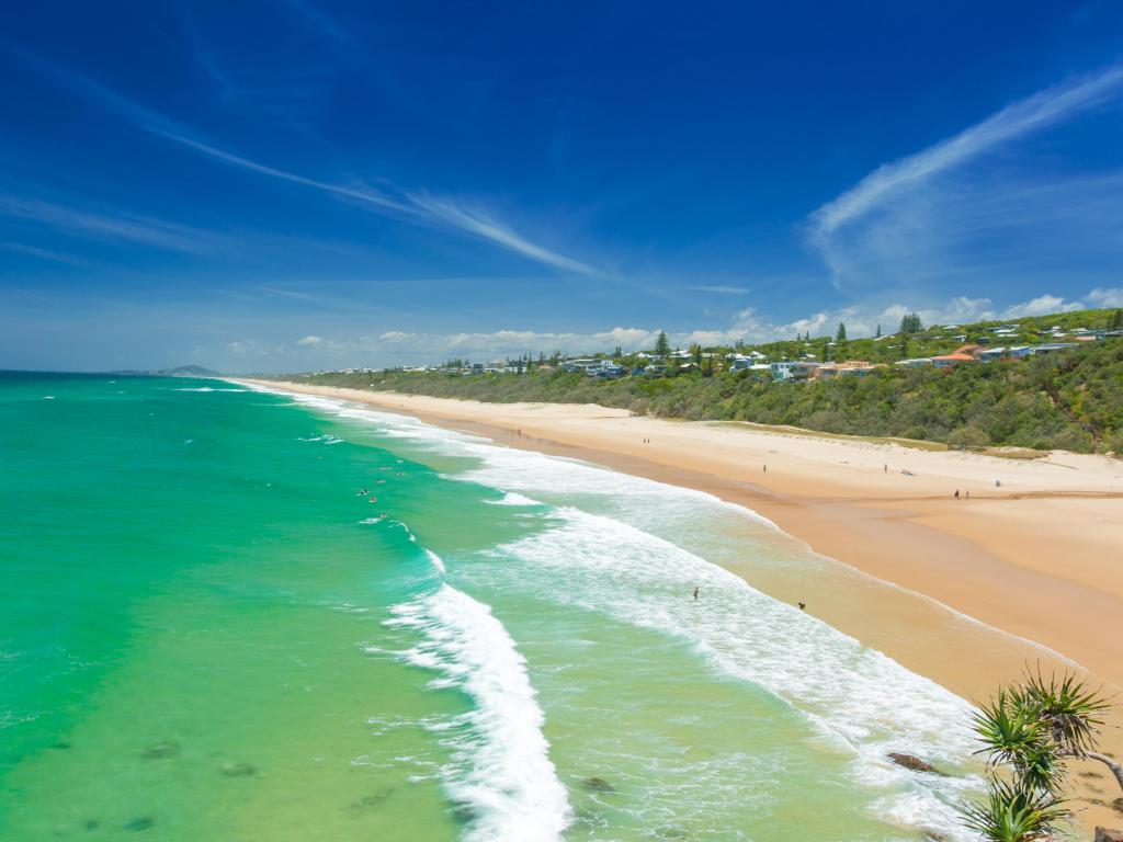 White sandy beach on the Sunshine Coast, Australia, with blue sky above