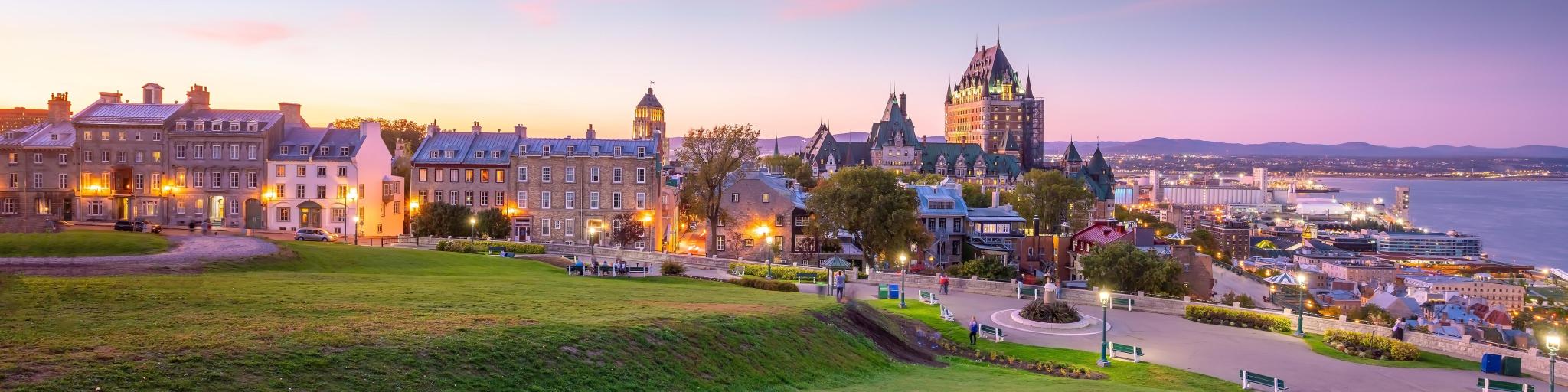 Quebec City, Canada taken as a panoramic view of Quebec City skyline with Saint Lawrence river at sunset.