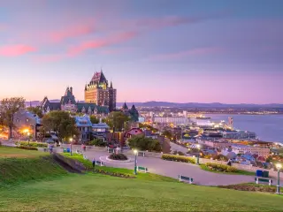 Quebec City, Canada taken as a panoramic view of Quebec City skyline with Saint Lawrence river at sunset.
