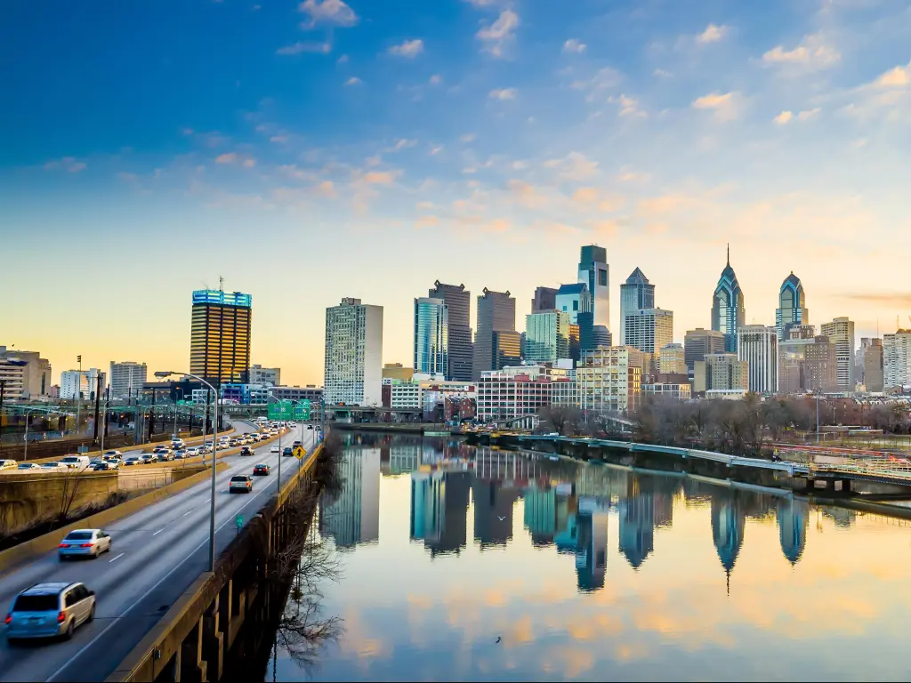 Philadelphia, Pennsylvania, USA taken with the downtown skyline at twilight, a road and river running towards it.