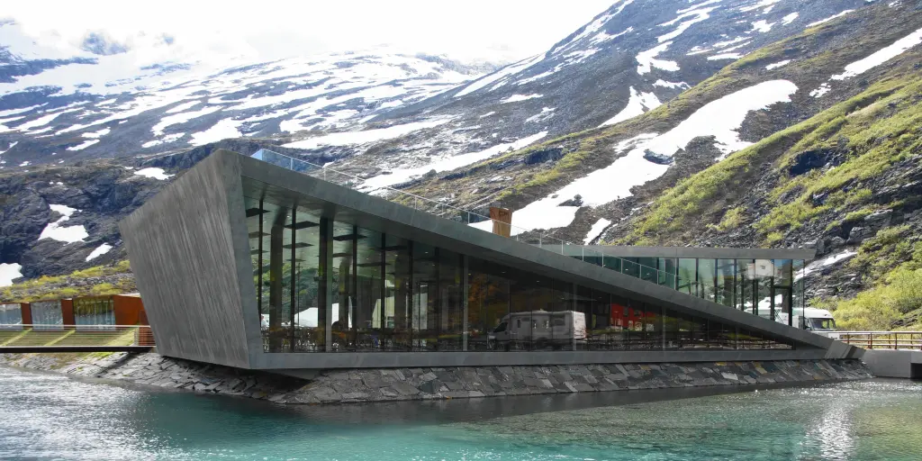 The striking Trollstigen Visitor Centre building sits next to a river in Norway