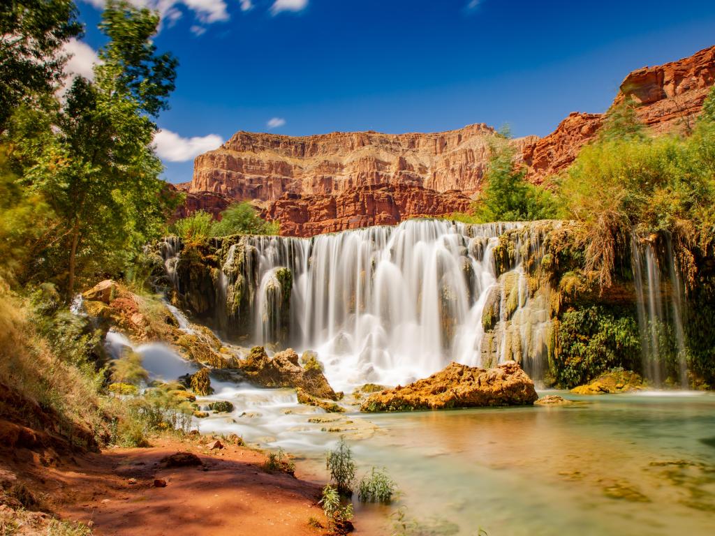 Grand Canyon waterfall inside the desert. Havasupai area and havasu river with blue and crystalline water.
