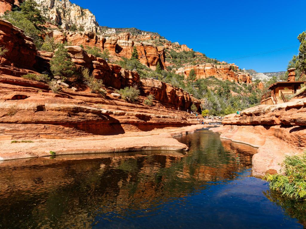 Natural red rock water slides in the Oak Creek Canyon near Sedona on a sunny day