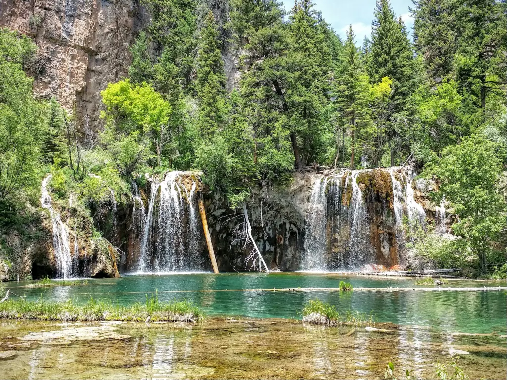 Waterfalls and pine forest surrounding Hanging Lake near Glenwood Springs, Colorado.