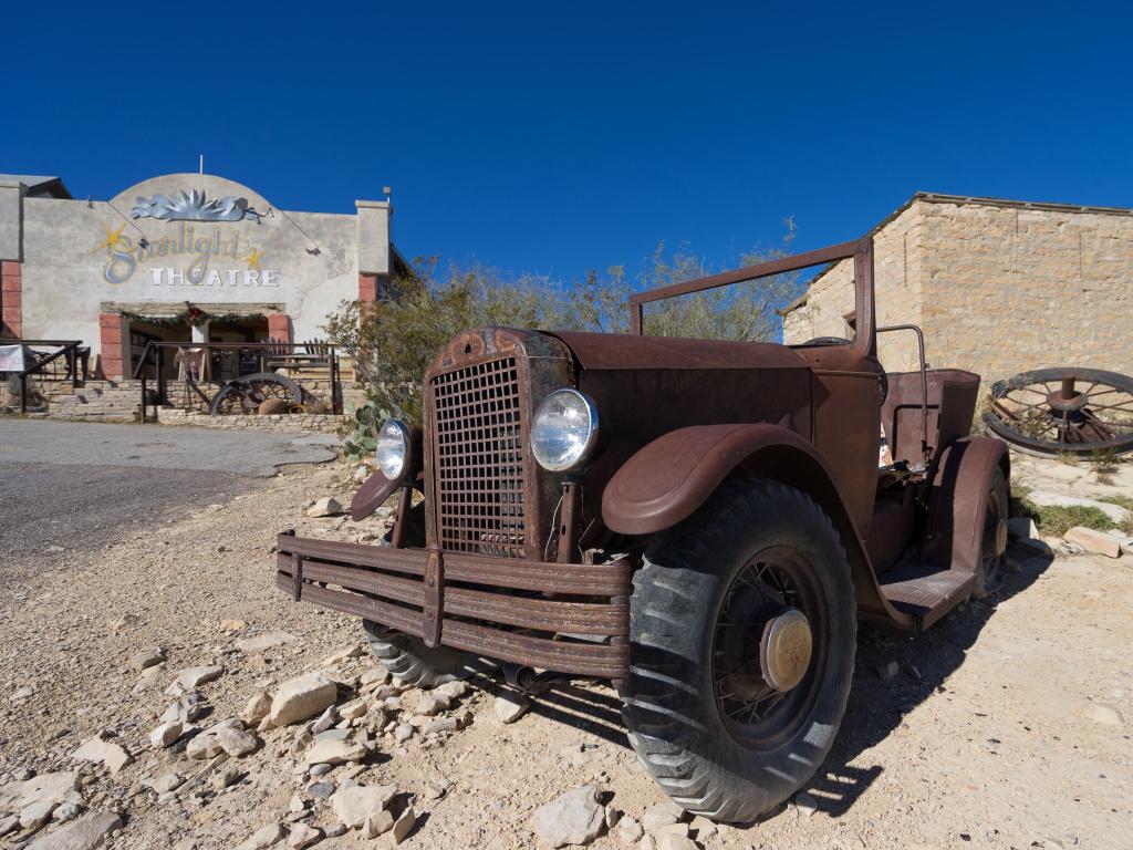 An old, abandoned car wreck in front of the Chisos Movie Theater in Terlingua Ghost Town in Texas. 
